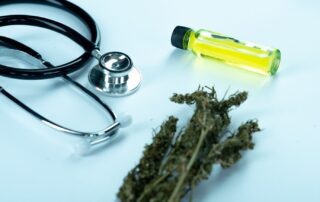 a stethoscope and a bottle of oil next to some dried herbs, who can prescribe medical marijuana