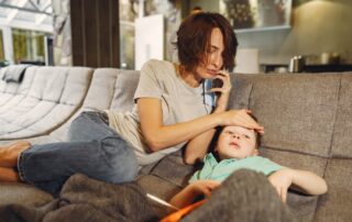 a woman on a couch with a child on her lap, Medical Marijuana For Epilepsy Treatment